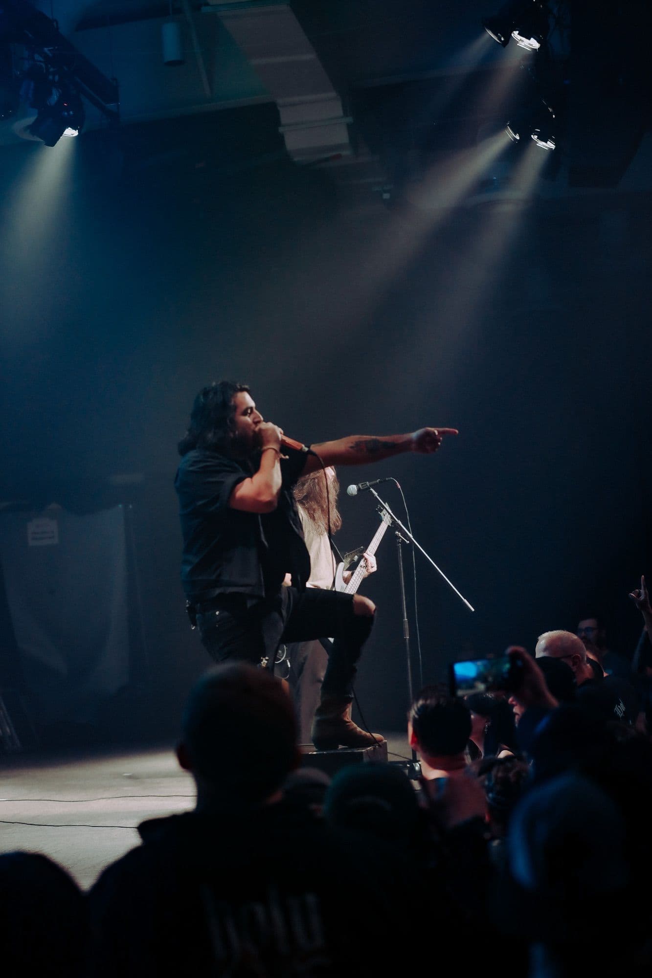 Bloodlines vocalist on stage under spotlights